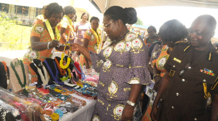 Nana Oye Lithur (2nd right), Minister of Gender, Children and Social Protection, inspecting an exhibition mounted by Prison officers. Looking on is Mr Emmanuel Adzator, acting Director General of the Ghana Prison's Service.